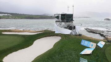 High winds blow against television towers and course signage during the delayed final round start the AT&T Pebble Beach Pro-Am at Pebble Beach Golf Links.
