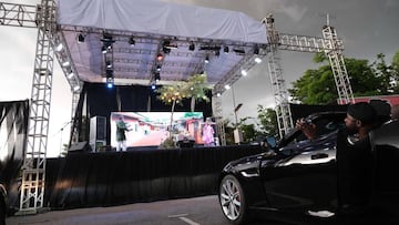 A spectator watches from his parked car a stage play called Pidgin English &quot;Grip am&quot; (Hold it) at a drive-in theatre in Abuja on May 30, 2020 as lockdown restrictions to contain the outbreak of COVID-19 coronavirus are relaxed in the country. (P