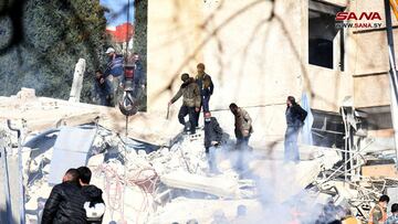 People inspect the damage at the site of an Israeli strike, according to sources, in the Mazzeh neighborhood of Damascus, Syria January 20, 2024. SANA/Handout via REUTERS ATTENTION EDITORS - THIS IMAGE WAS PROVIDED BY A THIRD PARTY. REUTERS IS UNABLE TO INDEPENDENTLY VERIFY THIS IMAGE. WATERMARK PROVIDED AT SOURCE