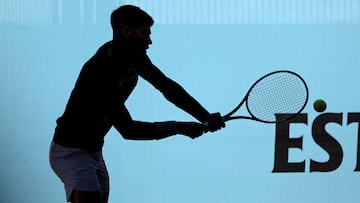 The silhouette of Spain's Carlos Alcaraz returning the ball during a training session before the 2024 ATP Tour Madrid Open tennis tournament is pictured at Caja Magica in Madrid on April 23, 2024. (Photo by Thomas COEX / AFP)