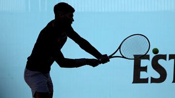 The silhouette of Spain's Carlos Alcaraz returning the ball during a training session before the 2024 ATP Tour Madrid Open tennis tournament is pictured at Caja Magica in Madrid on April 23, 2024. (Photo by Thomas COEX / AFP)