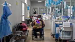 Wilfredo, 53, who recovered from COVID-19, poses for a photo on a wheelchair after being discharged from the Rebagliati Hospital in Lima on August 31, 2020. - More than 10,000 people have recovered from Covid-19 in Peru, which registers more than 660,000 cases and more than 29,000 deaths. (Photo by Ernesto BENAVIDES / AFP)