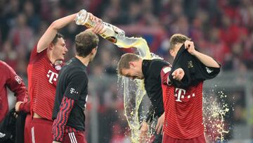 Benjamin Pavard pours beer over Julian Nagelsmann after Bayern secured a 10th consecutive Bundesliga title.