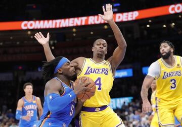 Oct 27, 2021; Oklahoma City, Oklahoma, USA; Oklahoma City Thunder forward Luguentz Dort (5) drives to the basket against Los Angeles Lakers guard Rajon Rondo (4) during the second half at Paycom Center. Oklahoma City won 123-115. Mandatory Credit: Alonzo 