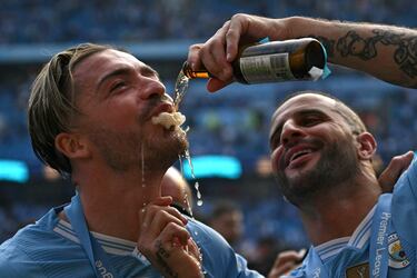 El defensor del City, Kyle Walker, le brinda una cerveza a Jack Grealish en la celebración del Manchester City como campeón de la Premier League 2024-25.
