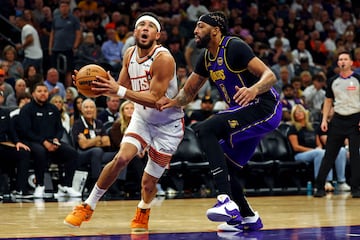 Oct 28, 2024; Phoenix, Arizona, USA; Phoenix Suns guard Devin Booker (1) drives to the basket against Los Angeles Lakers forward Anthony Davis (3) during the second half at Footprint Center. Mandatory Credit: Mark J. Rebilas-Imagn Images