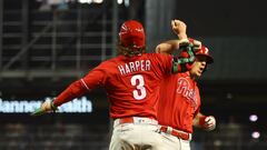 Oct 21, 2023; Phoenix, Arizona, USA; Philadelphia Phillies catcher J.T. Realmuto (10) reacts with Philadelphia Phillies designated hitter Bryce Harper (3) after hitting a two run home run against the Arizona Diamondbacks in the eighth inning during game five of the NLCS for the 2023 MLB playoffs at Chase Field. Mandatory Credit: Mark J. Rebilas-USA TODAY Sports