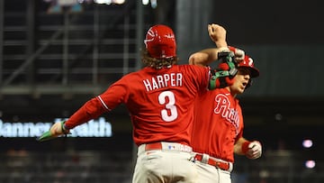Oct 21, 2023; Phoenix, Arizona, USA; Philadelphia Phillies catcher J.T. Realmuto (10) reacts with Philadelphia Phillies designated hitter Bryce Harper (3) after hitting a two run home run against the Arizona Diamondbacks in the eighth inning during game five of the NLCS for the 2023 MLB playoffs at Chase Field. Mandatory Credit: Mark J. Rebilas-USA TODAY Sports