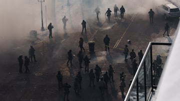Federal agents walk through a massive cloud of teargas near the site where a man identified as Alex Pretti was fatally shot by federal agents trying to detain him, in Minneapolis, Minnesota, U.S., January 24, 2026. REUTERS/Tim Evans