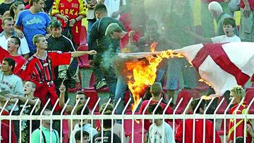 Macedonian soccer fans cheer as they burn the English flag during the national anthem ceremony prior to the start of their Euro 2004 championship qualifying match against England in Skopje September 6, 2003.    REUTERS/Oleg Popov