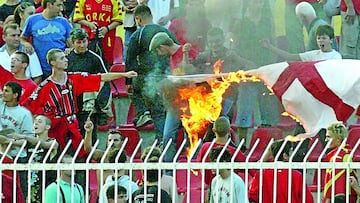 Macedonian soccer fans cheer as they burn the English flag during the national anthem ceremony prior to the start of their Euro 2004 championship qualifying match against England in Skopje September 6, 2003.    REUTERS/Oleg Popov