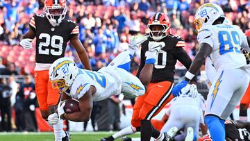 CLEVELAND, OHIO - NOVEMBER 03: J.K. Dobbins #27 of the Los Angeles Chargers dives past Cameron Mitchell #29 of the Cleveland Browns while scoring a rushing touchdown in the fourth quarter of a game at Huntington Bank Field on November 03, 2024 in Cleveland, Ohio. Jason Miller/Getty Images/AFP (Photo by Jason Miller / GETTY IMAGES NORTH AMERICA / Getty Images via AFP)