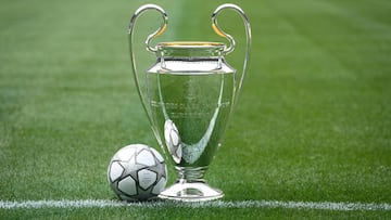 The Champions League trophy is seen with the official match ball