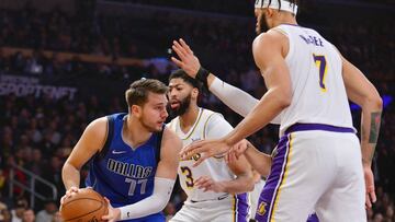 December 29, 2019; Los Angeles, California, USA; Dallas Mavericks forward Luka Doncic (77) controls the ball against Los Angeles Lakers forward Anthony Davis (3) center JaVale McGee (7) during the first half at Staples Center. Mandatory Credit: Gary A. Vasquez-USA TODAY Sports