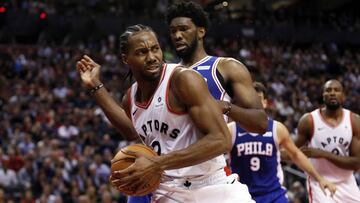 Oct 30, 2018; Toronto, Ontario, CAN; Toronto Raptors forward Kawhi Leonard (2)protects the ball from Philadelphia 76ers center Joel Embiid (21) at Scotiabank Arena. Toronto defeated Philadelphia. Mandatory Credit: John E. Sokolowski-USA TODAY Sports