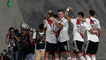 River Plate's midfielder Esequiel Barco (L, covered) celebrates with teammates after scoring his team's second goal against Argentinos Juniors from the penalty spot during their Argentine Professional Football League tournament match at El Monumental stadium in Buenos Aires, on February 12, 2023. (Photo by ALEJANDRO PAGNI / AFP)