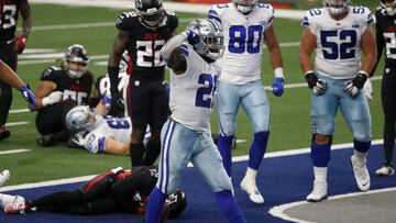Dallas Cowboys running back Ezekiel Elliott (21) celebrates running the ball for a touchdown as Atlanta Falcons' Keanu Neal (22) checks on injured teammate Damontae Kazee, bottom, in the first half of an NFL football game in Arlington, Texas, Sunday,