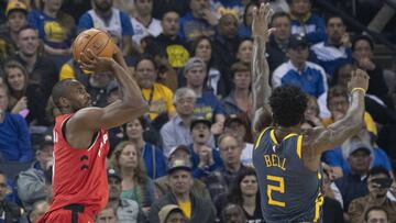 December 12, 2018; Oakland, CA, USA; Toronto Raptors forward Serge Ibaka (9) shoots the basketball against Golden State Warriors forward Jordan Bell (2) during the first quarter at Oracle Arena. Mandatory Credit: Kyle Terada-USA TODAY Sports