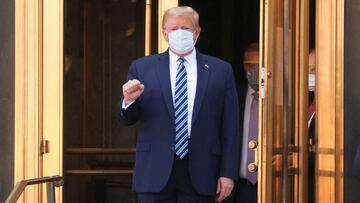 U.S. President Donald Trump makes a fist as he walks out the front doors of Walter Reed National Military Medical Center after a fourth day of treatment for the coronavirus disease (COVID-19) as he heads to the Marine One helicopter to return to the White