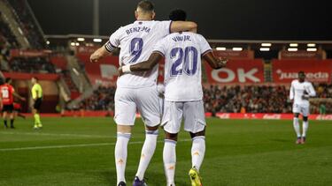 Real Madrid's Brazilian forward Vinicius Junior (R) celebrates with Real Madrid's French forward Karim Benzema after scoring his team's first goal during the Spanish League football match between RCD Mallorca and Real Madrid CF at the Son M
