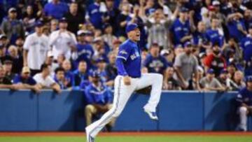 Ryan Goins con el último lanzamiento del juego entre los Blue Jays y los Royals.