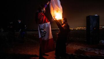 Supporters of the Peruvian candidate for the Fuerza Popular party, Keiko Fujimori, light Chinese lanterns before the candidate's arrival in Lima, on July 7, 2021. (Photo by Ernesto BENAVIDES / AFP)