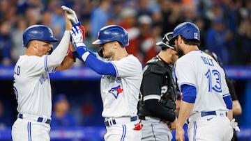 TORONTO, ON - APRIL 24: Cavan Biggio #8 of the Toronto Blue Jays celebrates at the plate with Whit Merrifield #15 and Brandon Belt #13 after Biggio hit a three-run home run in the fourth inning of their MLB game against the Chicago White Sox at Rogers Centre on April 24, 2023 in Toronto, Canada.   Cole Burston/Getty Images/AFP (Photo by Cole Burston / GETTY IMAGES NORTH AMERICA / Getty Images via AFP)