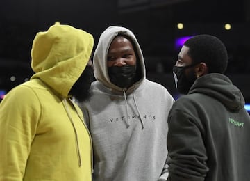 Irving (right) talks to fellow Brooklyn Nets stars Kevin Durant (centre) and James Harden during a time out in the first half of a preseason game against the LA Lakers in Los Angeles on Sunday.