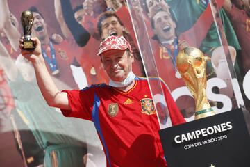 Seguidores de la selección española de fútbol se fotografían junto al trofeo.