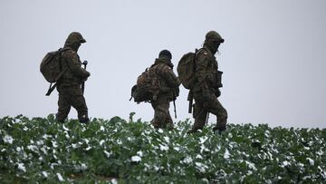 Polish soldiers walk in the field near the site of an explosion in Przewodow, a village in eastern Poland near the border with Ukraine, November 17, 2022. REUTERS/Kacper Pempel     TPX IMAGES OF THE DAY