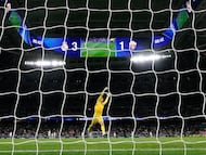 Elche's Argentine goalkeeper #01 Matias Dituro fails to stop a goal by Real Madrid's Turkish midfielder #15 Arda Guler during the Spanish league football match between Real Madrid CF and Elche CF at the Santiago Bernabeu Stadium in Madrid on March 14, 2026. (Photo by Oscar DEL POZO / AFP)