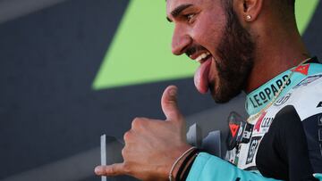 Leopard racing Italian rider Dennis Foggia holds the trophy during the podium ceremony as he celebrates his victory in the Moto 3 race as part of the Moto GP race of the British Grand Prix at Silverstone circuit in Northamptonshire, central England, on August 7, 2022. (Photo by Adrian DENNIS / AFP)