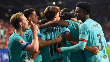 Barcelona players celebrate their second goal scored by Polish forward #09 Robert Lewandowski from the penalty spot, during the Spanish Liga football match between CA Osasuna and FC Barcelona at El Sadar stadium in Pamplona on September 3, 2023. (Photo by ANDER GILLENEA / AFP)