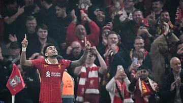 Liverpool's Colombian midfielder #07 Luis Diaz celebrates after scoring his team fourth goal during the UEFA Champions League football match between Liverpool and Bayer Leverkusen at Anfield stadium, in Liverpool, north west England, on November 5, 2024. (Photo by Paul ELLIS / AFP)