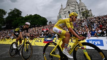 UAE Team Emirates - XRG team's Slovenian rider Tadej Pogacar wearing the overall leader's yellow jersey and Team Visma - Lease a bike team's Belgian rider Wout van Aert cycle past the Sacre-Coeur Basilica on the Butte de Montmartre during the 21st and final stage of the 112th edition of the Tour de France cycling race, 132.3 km between Mantes-la-Ville and Paris' Champs-Elysees Avenue, on July 27, 2025. (Photo by Loic VENANCE / AFP)