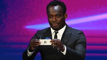 Former Ghanaian international footballer Michael Essien displays the slip of the group H during the draw for the UEFA Champions League football tournament in Istanbul on August 26, 2021. (Photo by OZAN KOSE / AFP)