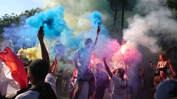 French supporters hold flares as they celebrate on Boulevard Poissonniere in Paris, on July 6, 2018.