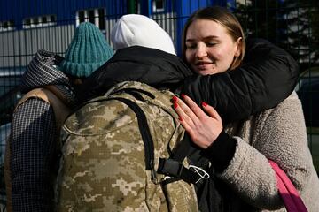 A group of Ukrainians embrace after crossing the Slovakian border into the city of Ubla.
