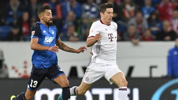 Hoffenheim's midfielder Kerem Demirbay (L) and Munich's Polish forward Robert Lewandowski vie for the ball during the German First division Bundesliga football match TSG 1899 Hoffenheim v FC Bayern Munich in Sinsheim, southwestern Germany on April 4, 2017. / AFP PHOTO / THOMAS KIENZLE / RESTRICTIONS: DURING MATCH TIME: DFL RULES TO LIMIT THE ONLINE USAGE TO 15 PICTURES PER MATCH AND FORBID IMAGE SEQUENCES TO SIMULATE VIDEO. == RESTRICTED TO EDITORIAL USE == FOR FURTHER QUERIES PLEASE CONTACT DFL DIRECTLY AT + 49 69 650050