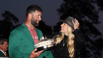 AUGUSTA, GEORGIA - APRIL 09: Jon Rahm of Spain, while holding the Masters trophy, laughs with his wife, Kelley during the Green Jacket Ceremony after winning the 2023 Masters Tournament at Augusta National Golf Club on April 09, 2023 in Augusta, Georgia.   Christian Petersen/Getty Images/AFP (Photo by Christian Petersen / GETTY IMAGES NORTH AMERICA / Getty Images via AFP)