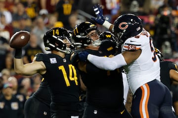 Oct 5, 2023; Landover, Maryland, USA; Washington Commanders quarterback Sam Howell (14) passes the ball under pressure from Chicago Bears defensive end DeMarcus Walker (95) during the second quarter at FedExField. Mandatory Credit: Geoff Burke-USA TODAY Sports