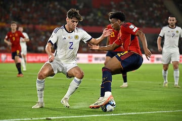 Scotland's defender #02 Aaron Hickey vies with Spain's defender #03 Alejandro Balde during the EURO 2024 first round group A qualifying football match between Spain and Scotland at the La Cartuja stadium in Seville on October 12, 2023. (Photo by JAVIER SORIANO / AFP)