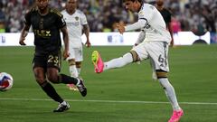 Jul 4, 2023; Los Angeles, California, USA;  LA Galaxy midfielder Riqui Puig (6) shoots the ball past Los Angeles FC midfielder Kellyn Acosta (23) during the first half at Rose Bowl. Mandatory Credit: Kiyoshi Mio-USA TODAY Sports