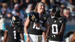 Trevor Lawrence #16 and Calvin Ridley #0 of the Jacksonville Jaguars walks across the field