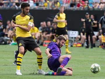 Liverpool's Adam Lallana (R) vies for the ball with Borussia Dortmund's Nuri Sahin (L) during the 2018 International Champions Cup at Bank of America Stadium in Charlotte, North Carolina, on July 22, 2018.  / AFP PHOTO / JIM WATSON