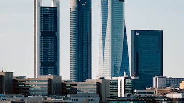 Madrid, Spain - January 1, 2022: A cityscape view featuring the Cuatro Torres Business Area skyscrapers, a prominent financial district in Madrid, Spain.