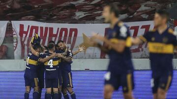 Argentina's Boca Juniors Carlos Tevez (Covered) celebrates with teammates after scoring against Brazil's Internacional during their closed-door Copa Libertadores round before the quarterfinals football match at Beira Rio stadium in Porto Alegre, Brazil, on December 2, 2020. (Photo by DIEGO VARA / various sources / AFP)