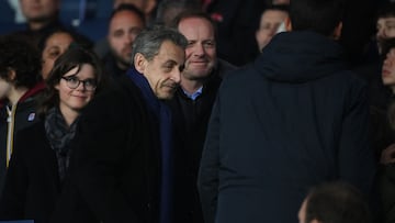 Former French President Nicolas Sarkozy (C, left) and the General Director of the Tour de France Christian Prudhomme (C) attend the French L1 football match between Paris Saint-Germain (PSG) and Lens (RCL) at the Parc des Princes in Paris, on April 15, 2023. (Photo by FRANCK FIFE / AFP)