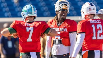 American quarterback Joe Milton III of Tennessee (5) talks with American quarterback Michael Pratt of Tulane (7) and American quarterback Carter Bradley of South Alabama (12) during practice.