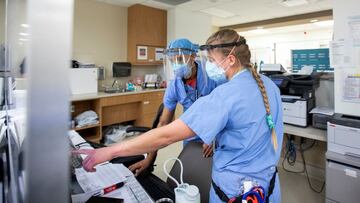 Emergency room nurse Janelle Van Halteren, right, speaks with her colleague as the Omicron coronavirus variant continues to put pressure on Humber River Hospital in Toronto, Ontario, Canada January 20, 2022. Picture taken January 20, 2022. REUTERS/Carlos Osori
